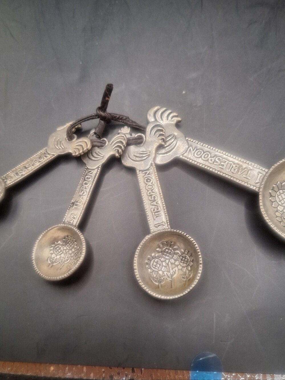 Measuring spoons featuring a rooster and sunflower design